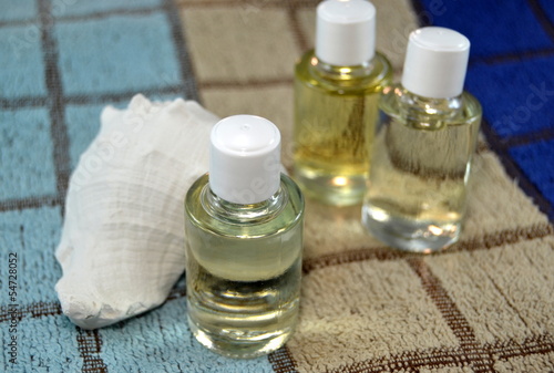 Photo: Conch sea and natural oils on bath towel, close up Conch sea and natural oils on bath towel, close up