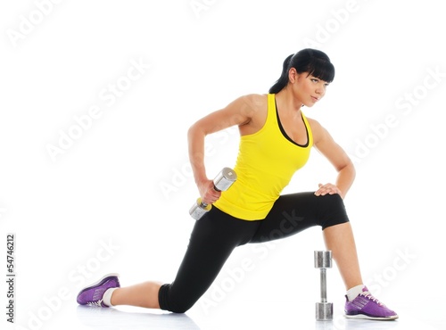 Photo: Beautiful girl doing fitness exercise with dumbbells Beautiful girl doing fitness exercise with dumbbells