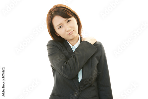 Photo: 肩こりに悩む女性社員 肩こりに悩む女性社員