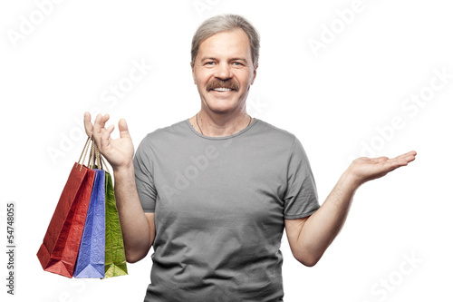 Photo: smiling mature man holding shopping bags isolated on white backg smiling mature man holding shopping bags isolated on white backg