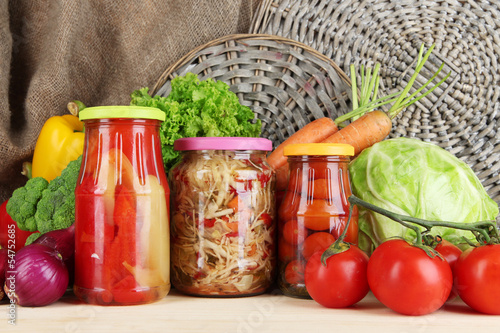 Photo: Fresh vegetables and canned on table close up Fresh vegetables and canned on table close up