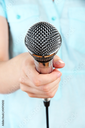 Photo: Female with microphone close-up background Female with microphone close-up background