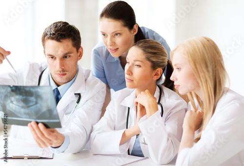 Photo: group of doctors looking at x-ray group of doctors looking at x-ray