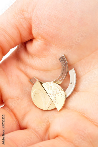 Photo: Euro fallen apart - coin in hand Euro fallen apart - coin in hand