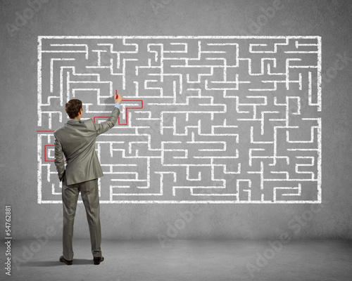 Photo: Businessman solving labyrinth problem Businessman solving labyrinth problem
