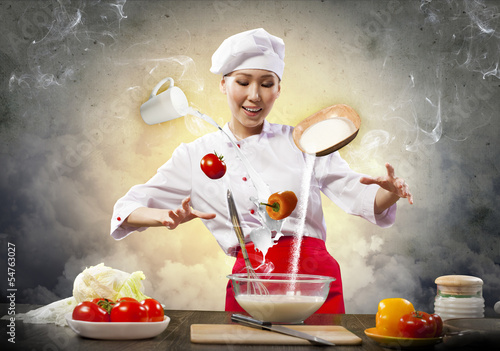Photo: Asian female cooking with magic Asian female cooking with magic