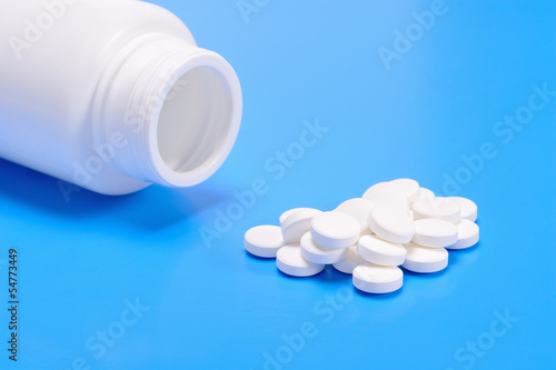 Photo: Pills spilling from a prescription medicine bottle Pills spilling from a prescription medicine bottle
