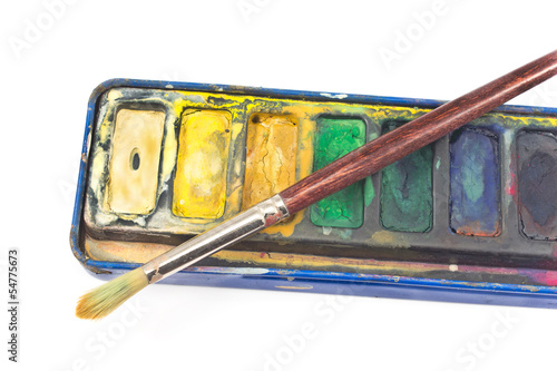Photo: Closeup of Watercolor paints and paintbrush on white Closeup of Watercolor paints and paintbrush on white