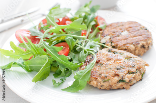 Photo: Ground fish patty with arugula tomato salad Ground fish patty with arugula tomato salad