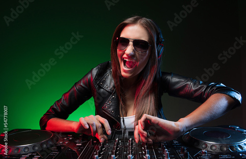 Photo: Female DJ. Happy young female DJ in sunglasses playing music and Female DJ. Happy young female DJ in sunglasses playing music and