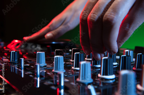Photo: DJ at work. Close-up of DJ hands making music DJ at work. Close-up of DJ hands making music