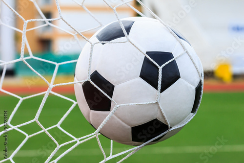 Photo: soccer ball in goal net soccer ball in goal net