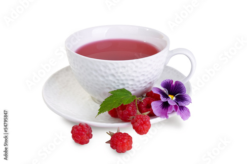 Photo: White mug with berry tea, raspberry and pansies White mug with berry tea, raspberry and pansies