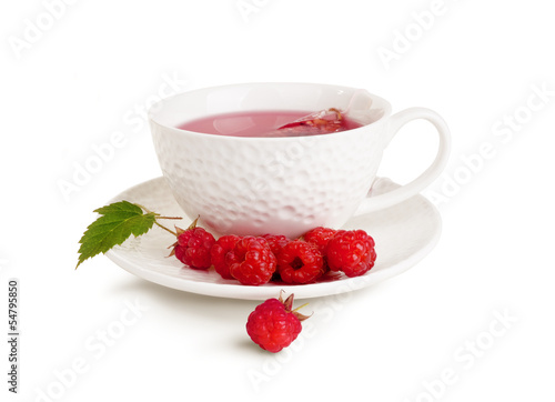 Photo: White mug of tea and raspberry White mug of tea and raspberry