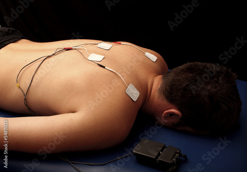 Photo: Man with TENS on his back Man with TENS on his back