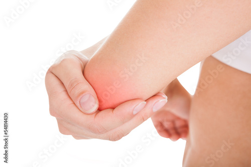Photo: Woman with elbow pain Woman with elbow pain