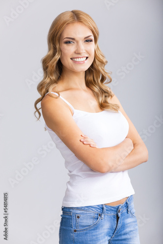 Photo: Happy smiling blond woman, over grey Happy smiling blond woman, over grey