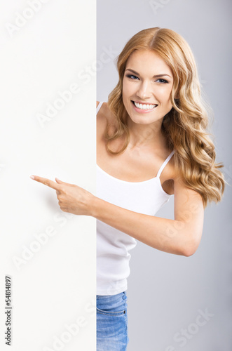 Photo: Woman with blank signboard, on grey Woman with blank signboard, on grey