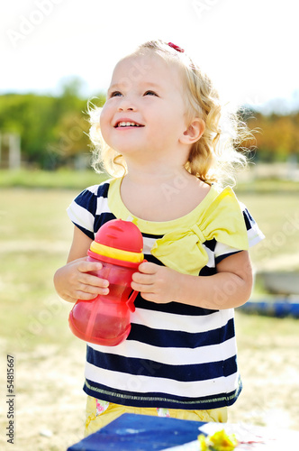 Photo: toddler girl with bottle of water toddler girl with bottle of water