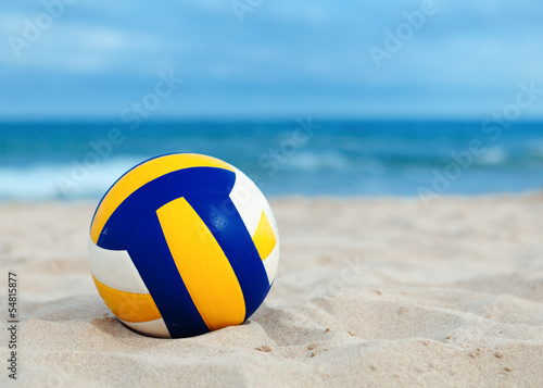 Photo: ball is lying on sand near sea ball is lying on sand near sea