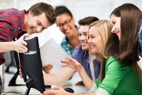 Photo: students looking at computer monitor at school students looking at computer monitor at school