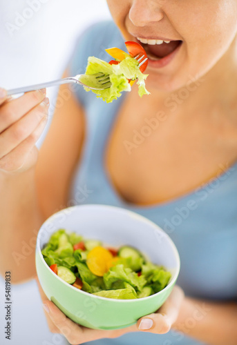 Photo: woman eating salad with vegetables woman eating salad with vegetables