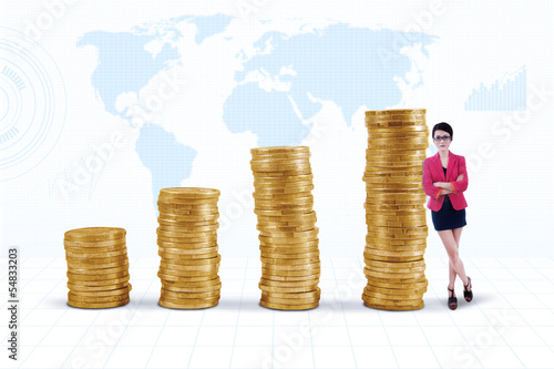 Photo: Businesswoman and gold coins chart Businesswoman and gold coins chart