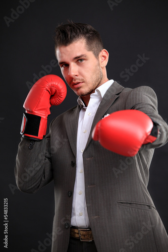 Photo: Business man ready to fight with boxing gloves Business man ready to fight with boxing gloves