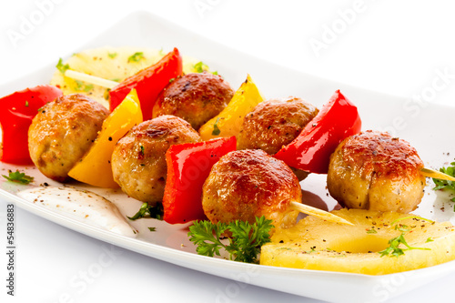 Photo: Grilled meat and vegetables on white background Grilled meat and vegetables on white background