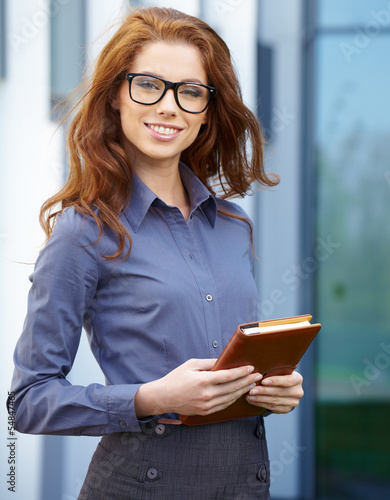 Photo: Beautiful business woman on the background of the modern office Beautiful business woman on the background of the modern office