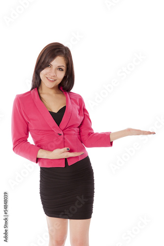 Photo: Young woman in business outfit gestures towards a product. Young woman in business outfit gestures towards a product.