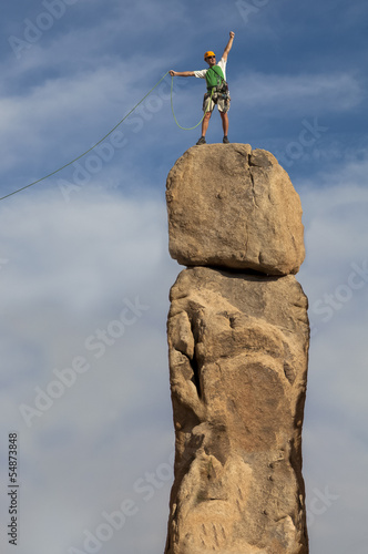 Photo: Successful climber at the top. Successful climber at the top.