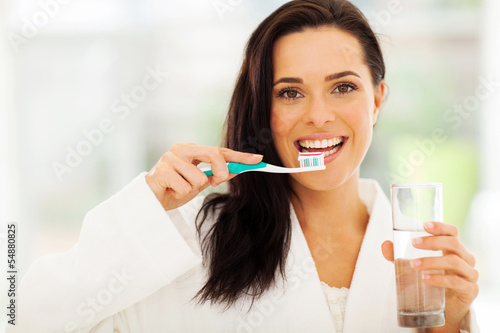 Photo: cute woman brushes her teeth cute woman brushes her teeth