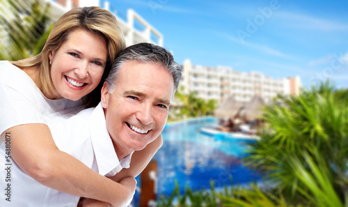 Photo: Happy senior couple at tropical resort. Happy senior couple at tropical resort.