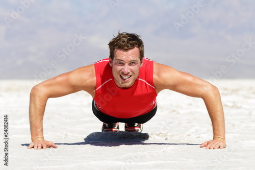 Photo: Fitness man doing push ups training outdoor Fitness man doing push ups training outdoor