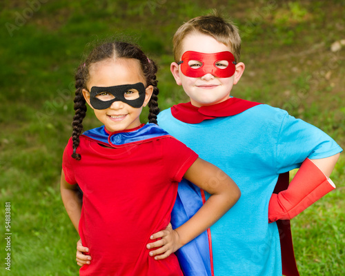 Photo: Pretty mixed race girl and boy pretending to be superheroes Pretty mixed race girl and boy pretending to be superheroes