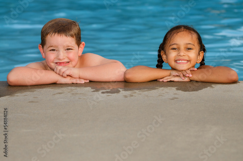 Photo: Portrait of Caucasian boy and mixed race girl in pool Portrait of Caucasian boy and mixed race girl in pool