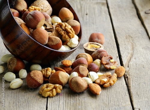 Photo: Mix nuts (almonds, hazelnuts, walnuts) on a wooden table Mix nuts (almonds, hazelnuts, walnuts) on a wooden table