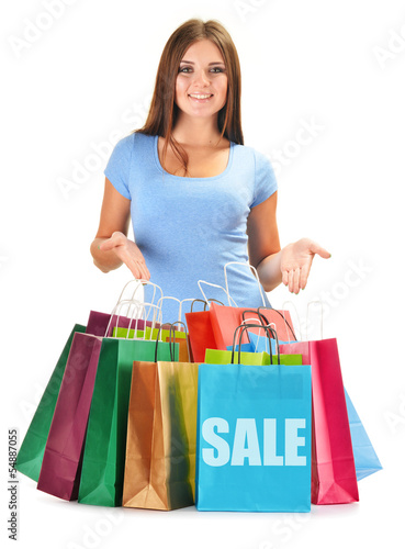 Photo: Young happy woman with colorful paper shopping bags isolated Young happy woman with colorful paper shopping bags isolated