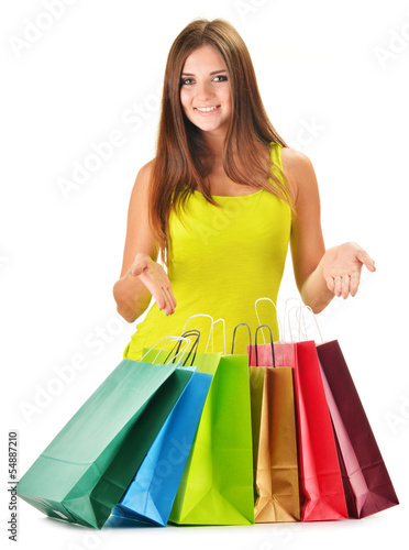Photo: Young happy woman with colorful paper shopping bags isolated Young happy woman with colorful paper shopping bags isolated