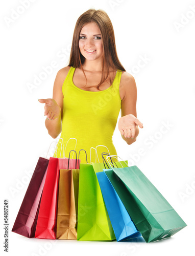 Photo: Young happy woman with colorful paper shopping bags isolated Young happy woman with colorful paper shopping bags isolated