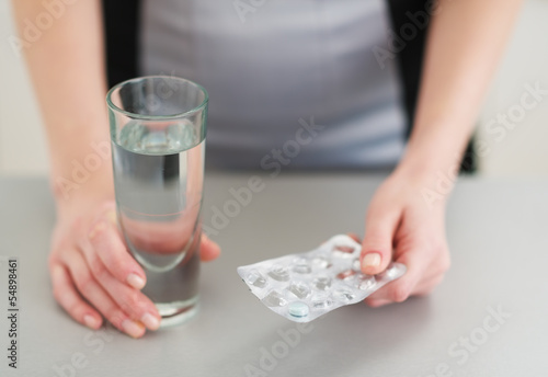 Photo: Closeup on pills in hand of young woman Closeup on pills in hand of young woman