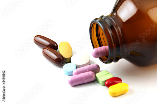 Photo: Pill of many color Beside the bottle. Pill of many color Beside the bottle.