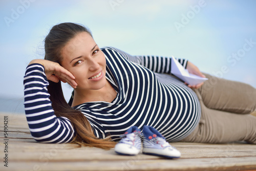 Photo: pregnant woman on the sea coast pregnant woman on the sea coast