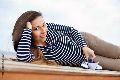 Photo: pregnant woman on the sea coast pregnant woman on the sea coast