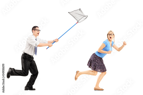 Photo: Full length portrait of a scared young female trying to runaway Full length portrait of a scared young female trying to runaway