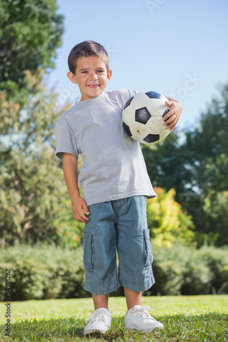 Photo: Young boy holding football Young boy holding football