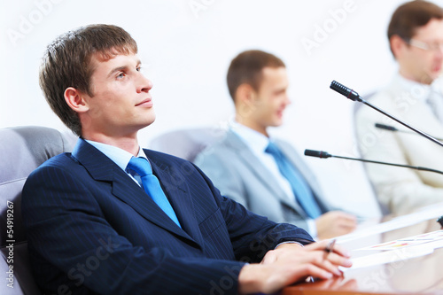 Photo: Three businesspeople at meeting Three businesspeople at meeting