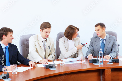 Photo: Four businesspeople at meeting Four businesspeople at meeting