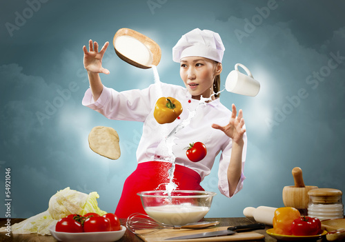 Photo: Asian female cooking with magic Asian female cooking with magic